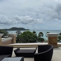 A patio with chairs and a view of the ocean in Phuket